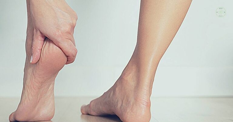 a person massaging an elderly individual’s swollen heel area indicating potential heel pain or plantar issues