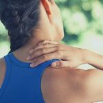 a person performing a neck stretch exercise to relieve tension and ztuhlost svalů in the shoulder and upper back area