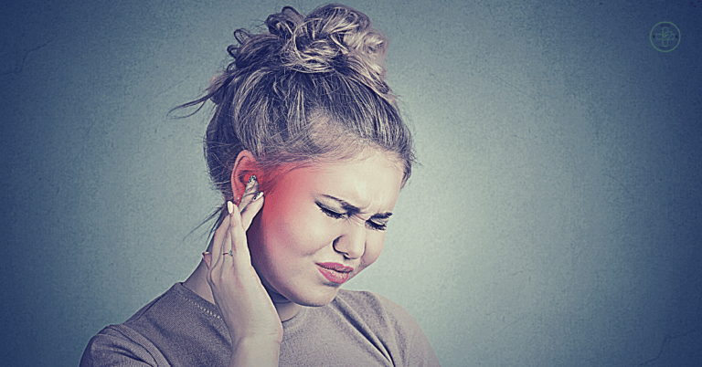 a person holding their ear in pain, indicating symptoms of earache or discomfort.