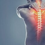 Silné Léky Na Bolest Zad Na Předpis! Celý Seznam 16 a person clutching their neck and upper back showing highlighted spinal pain areas, indicating severe backache.