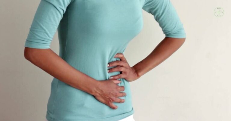 a person holding their lower left abdomen area indicating possible discomfort or pain.