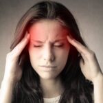 Jak Se Sami Můžete Zbavit Bolesti Hlavy Od Krční Páteře! 17 a person holding their temples, illustrating tension or cervikorurální bolesti hlavy with highlighted forehead pain area