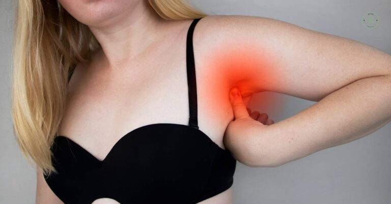 a person indicating pain or discomfort in the underarm area near the armpit, highlighting potential tension or inflammation.