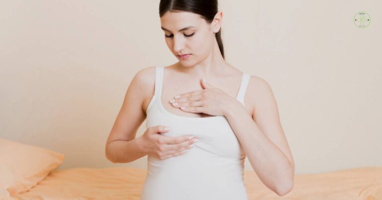 a woman examining her breast, illustrating potential breast tenderness or sensitivity during early pregnancy