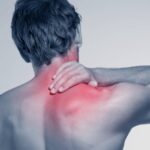 Jak Si Odblokovat Zablokovaný Krk Doma! 16 a person holding their neck in pain, highlighting stiff or ztuhlý krk with red inflammation.