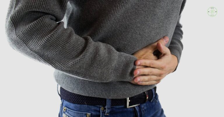a person clutching their lower abdomen, indicating possible abdominal pain or discomfort in the pelvic region.