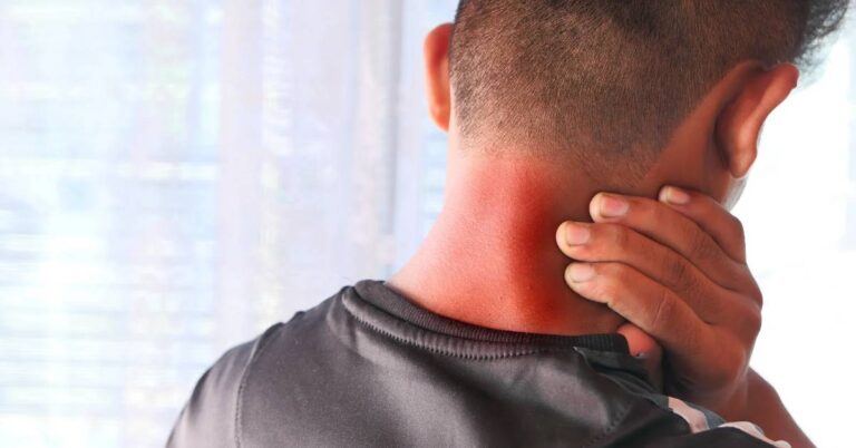 a person holding their neck in apparent discomfort, suggesting possible strain or pain.
