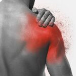 a person holding their shoulder in pain, highlighting the area affected by bolest ramene during rest or sleep