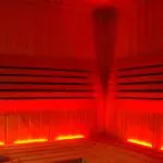 Ionizátor v infrasauně – proč si ho pořídit? 2 an infrared sauna interior with built-in red light therapy panels enhancing air ionization and air quality for relaxation and regeneration