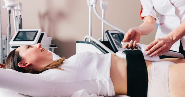 a woman undergoing muscle stimulation therapy with EMS device, where electrodes attached to her leg are activated by a healthcare professional.