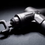 Jak správně používat masážní pistoli: Průvodce pro začátečníky 7 a close-up of a cordless masážní pistole with adjustable head and ergonomic grip for deep tissue massage