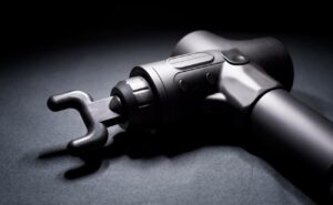 a close-up of a cordless masážní pistole with adjustable head and ergonomic grip for deep tissue massage