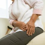 a person holding their groin area indicating discomfort or pain near the pubic region