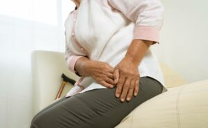 a person holding their groin area indicating discomfort or pain near the pubic region